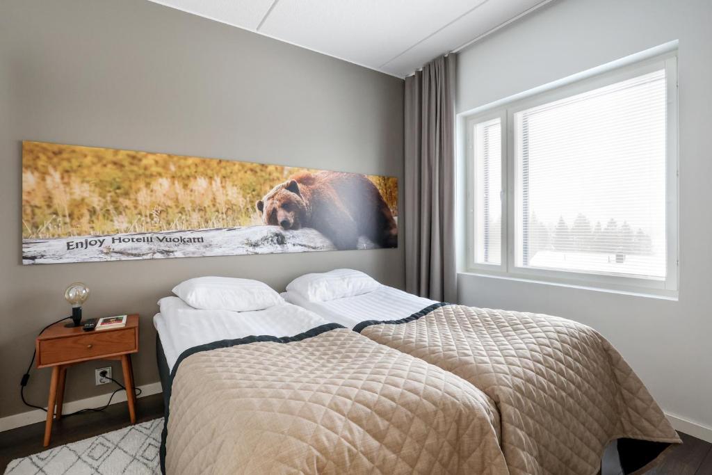 Postel nebo postele na pokoji v ubytování Aateli Lakeside Chalets - former Vuokatti Suites