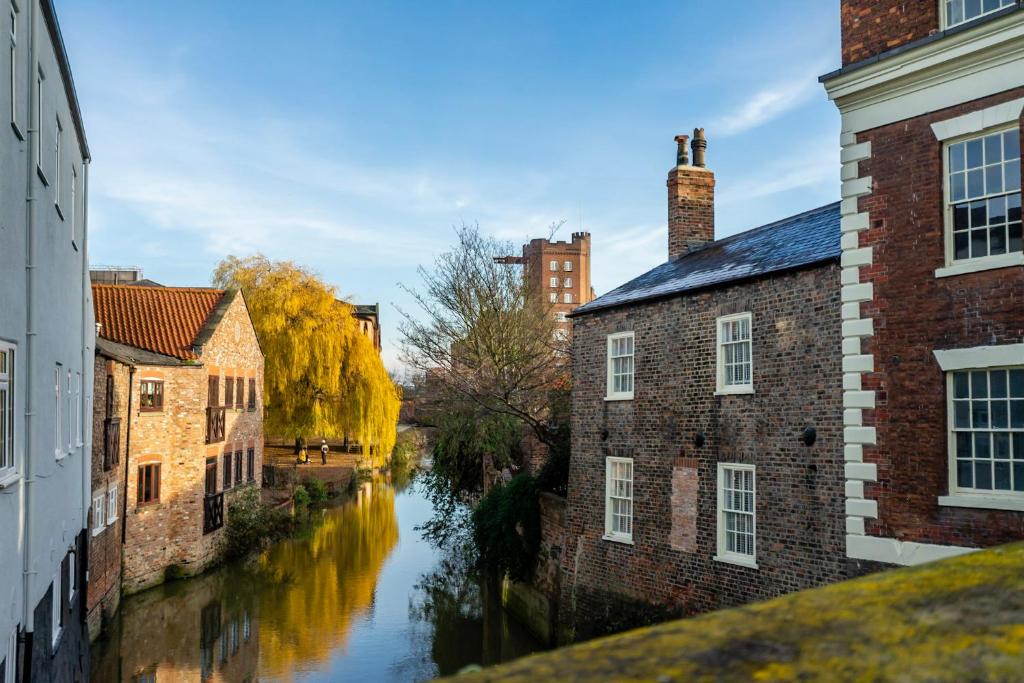 a view of a river between two buildings at Walmgate Cottage in York