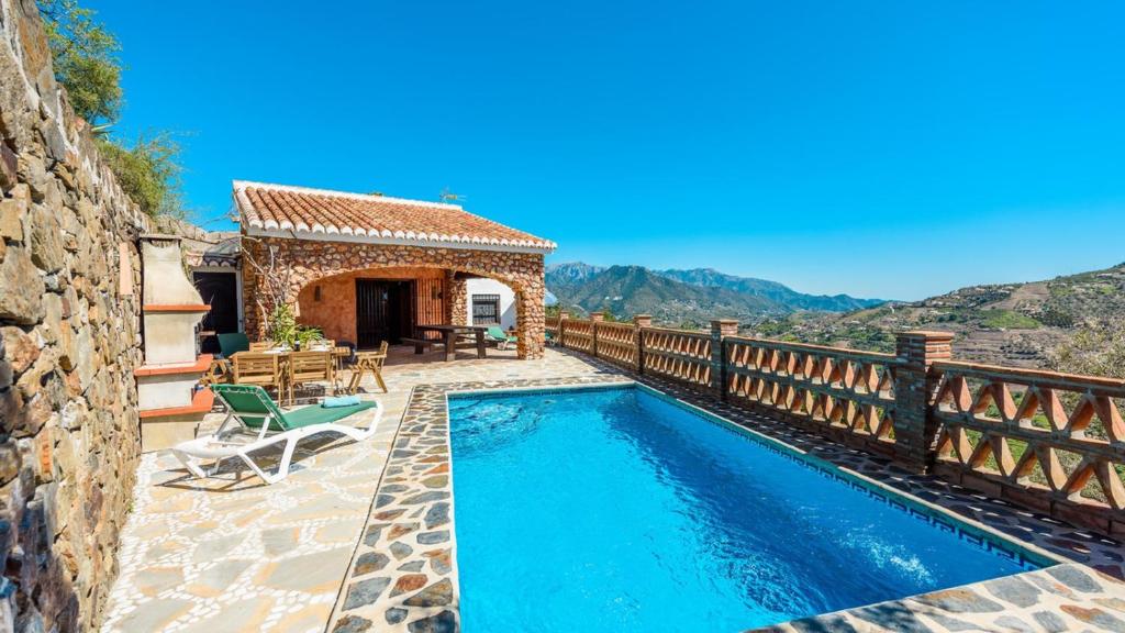 a villa with a swimming pool and a house at Finca Tarabita Competa by Ruralidays in Cómpeta