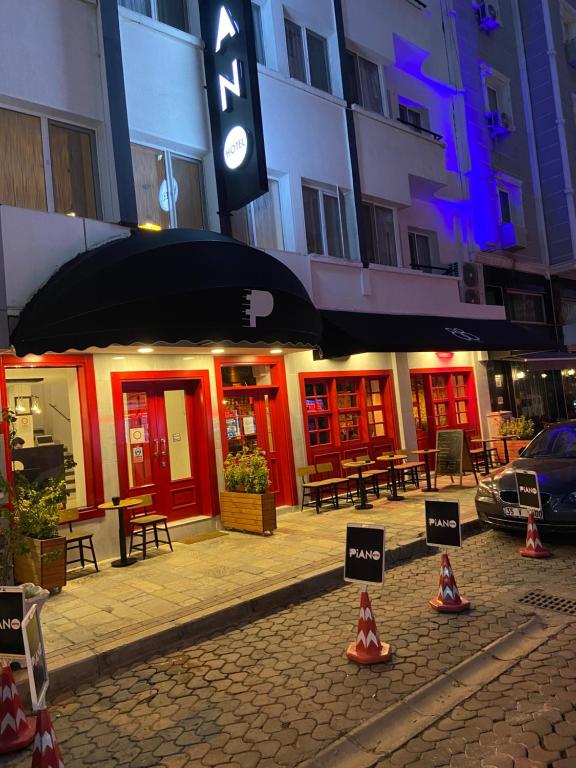 a street with cones on the sidewalk in front of a building at Piano Hotel in İzmir