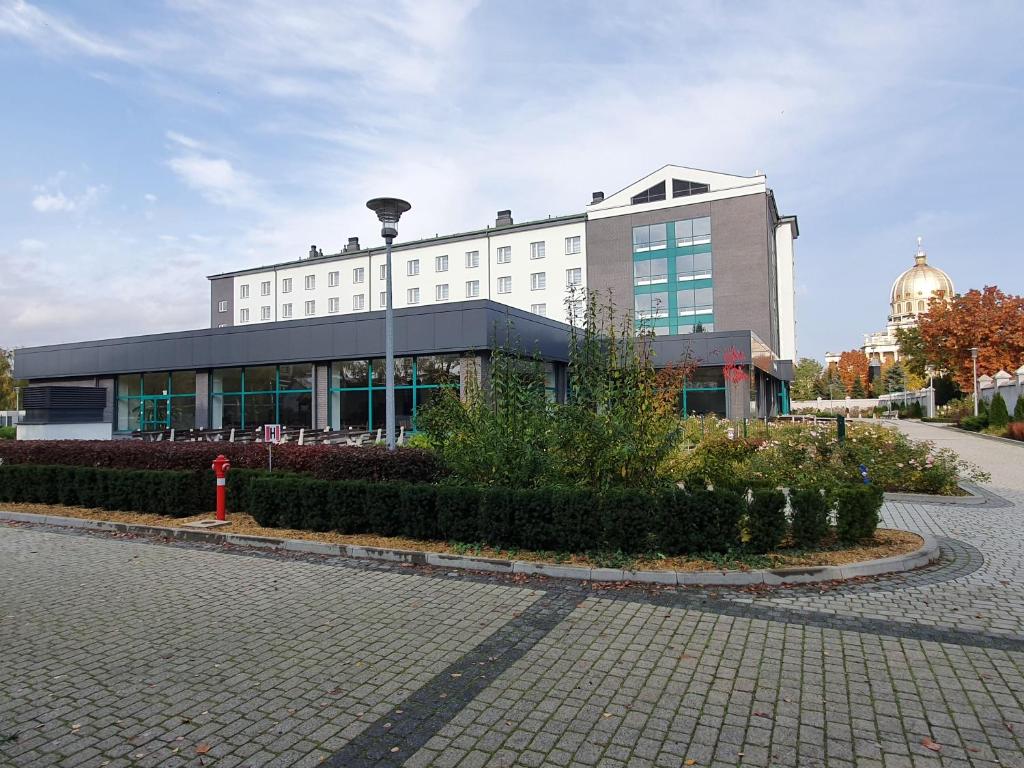 a large building with a red fire hydrant in front of it at Dom Pielgrzyma BETLEJEM in Licheń Stary