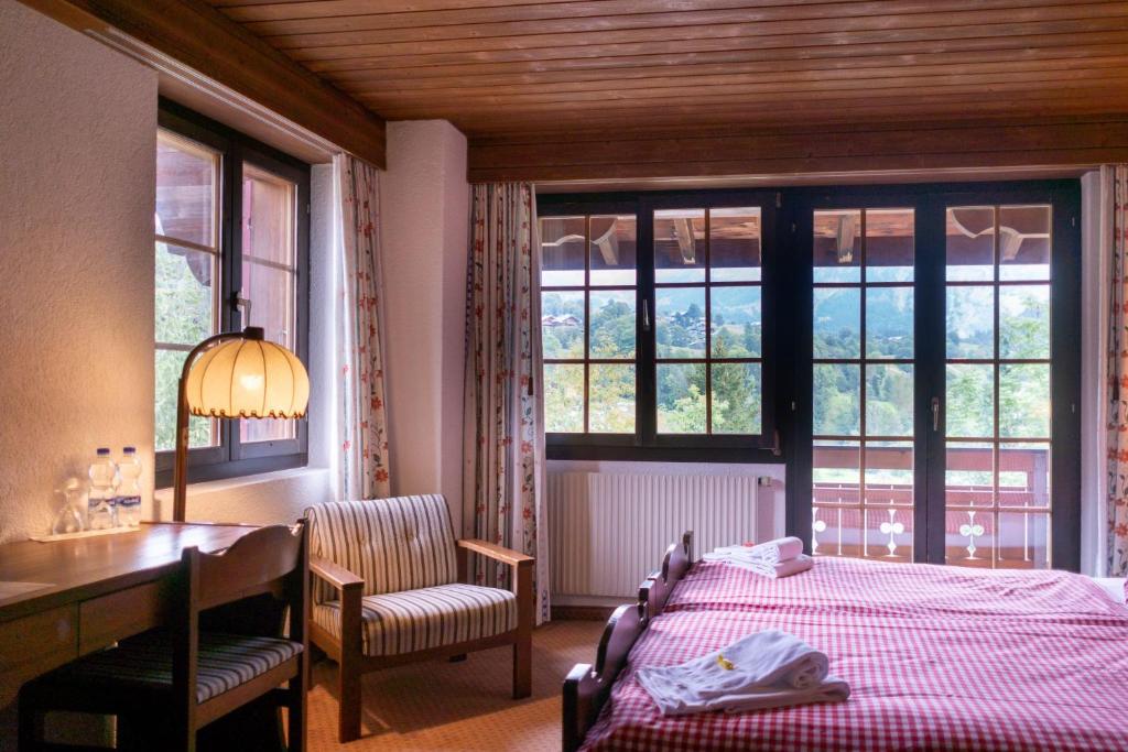 Postel nebo postele na pokoji v ubytování Hotel Gletscherblick Grindelwald