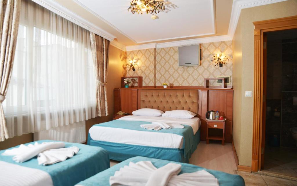 Postel nebo postele na pokoji v ubytování Old City Viva Hotel