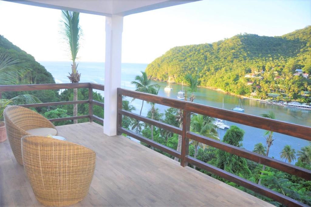 a balcony with a view of the ocean at Marigot Palms Luxury Caribbean Apartment Suites in Marigot Bay