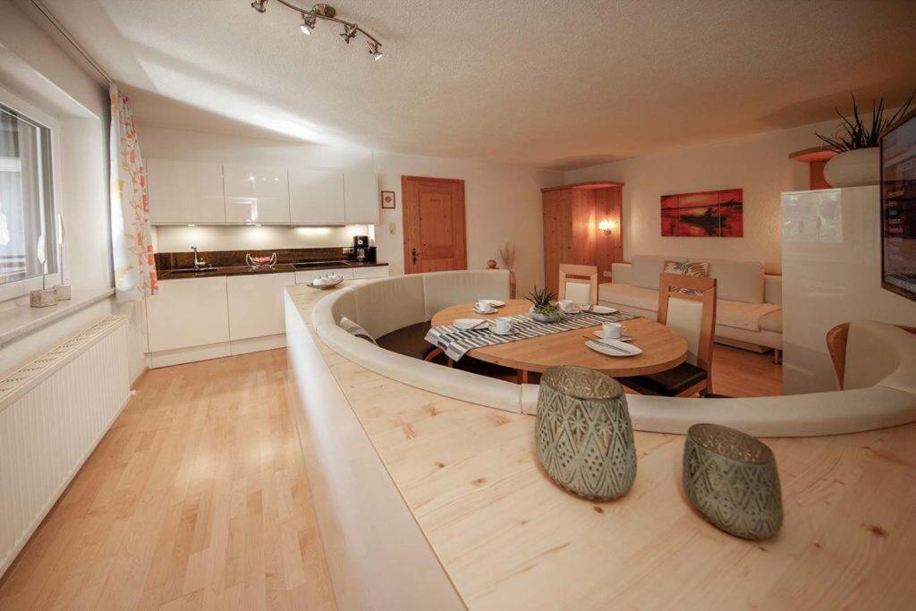 a large living room with a table and a kitchen at Haus Ingrid in Sölden
