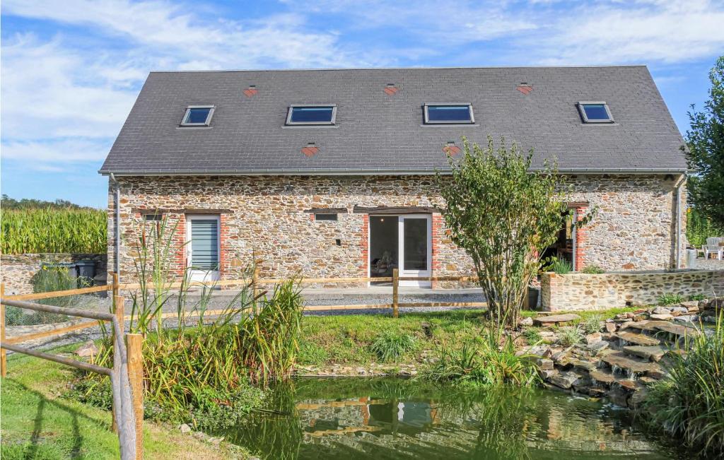 a stone house with a pond in front of it at Beautiful Home In La Meauffe With 2 Bedrooms And Wifi in La Meauffe