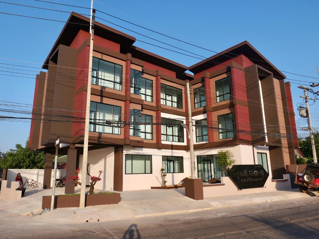 a building on the corner of a street at Nub Thong Residence in Kalasin