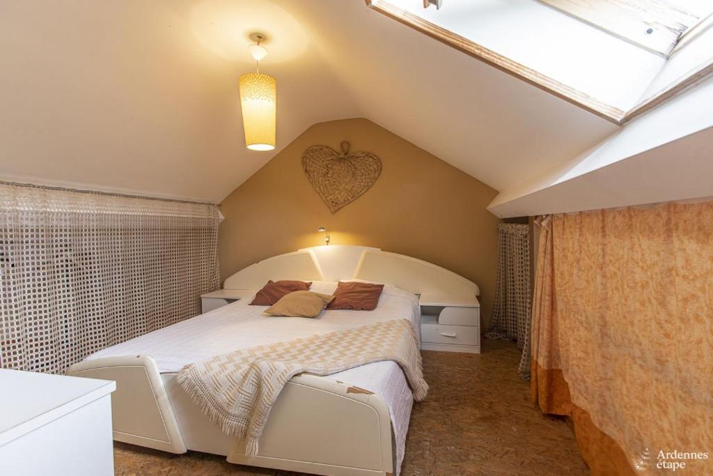 a bedroom with a large bed in a attic at Le Loft in Stoumont
