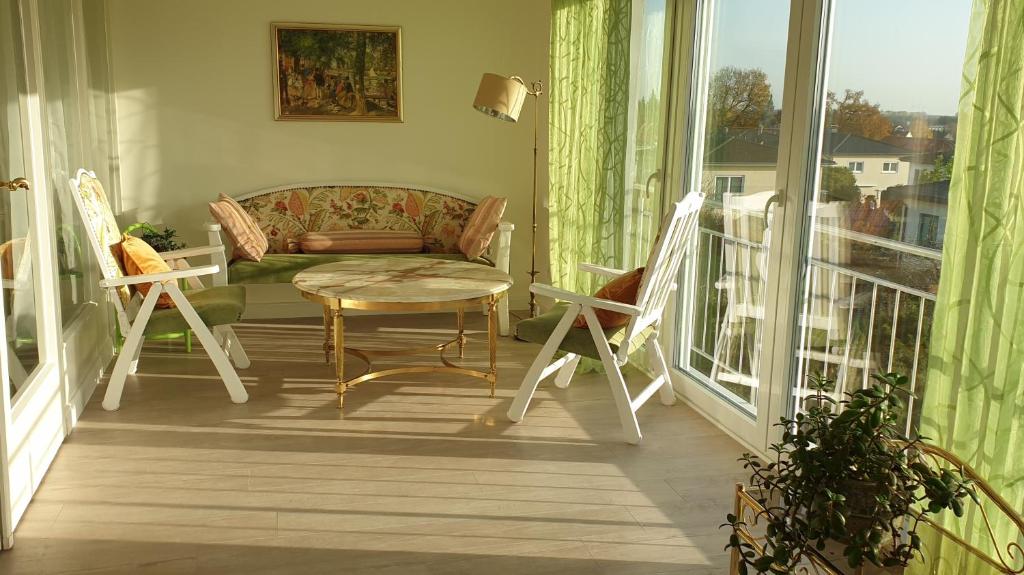 a living room with a couch and chairs on a balcony at Ferienwohnung zum Wohlfühlen in Lengerich