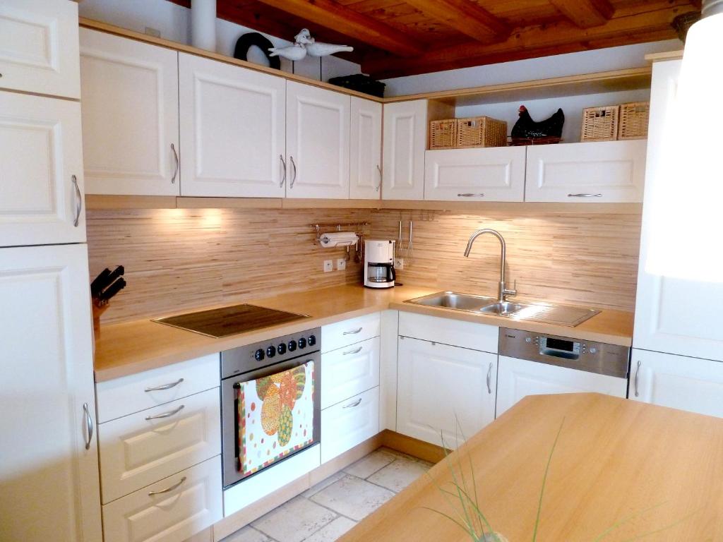a kitchen with white cabinets and a sink at Appartement de 2 chambres avec jardin clos et wifi a Beblenheim in Beblenheim