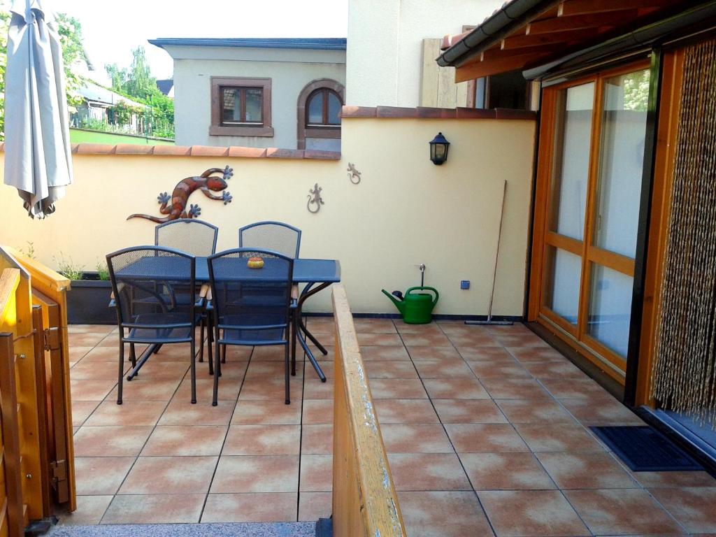 a patio with a table and chairs on it at Appartement de 2 chambres avec jardin clos et wifi a Beblenheim in Beblenheim