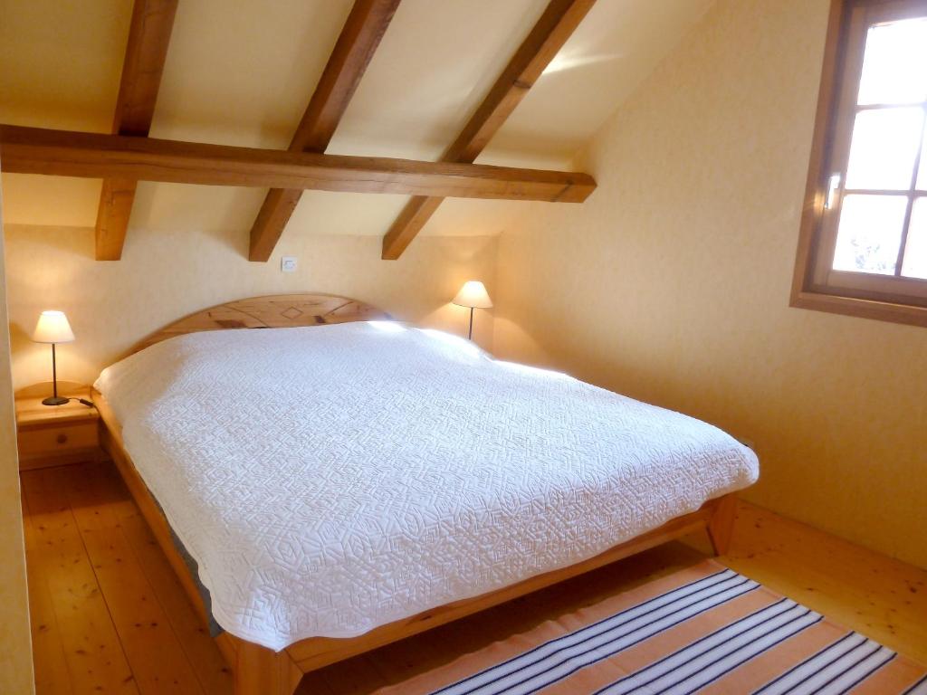 a bedroom with a white bed in a attic at Appartement de 2 chambres avec jardin clos et wifi a Beblenheim in Beblenheim