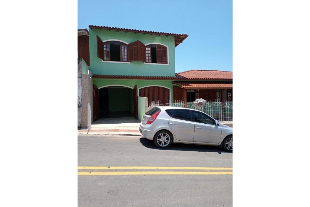 une voiture garée devant une maison dans l'établissement Ap Família no Estreito, à Florianópolis