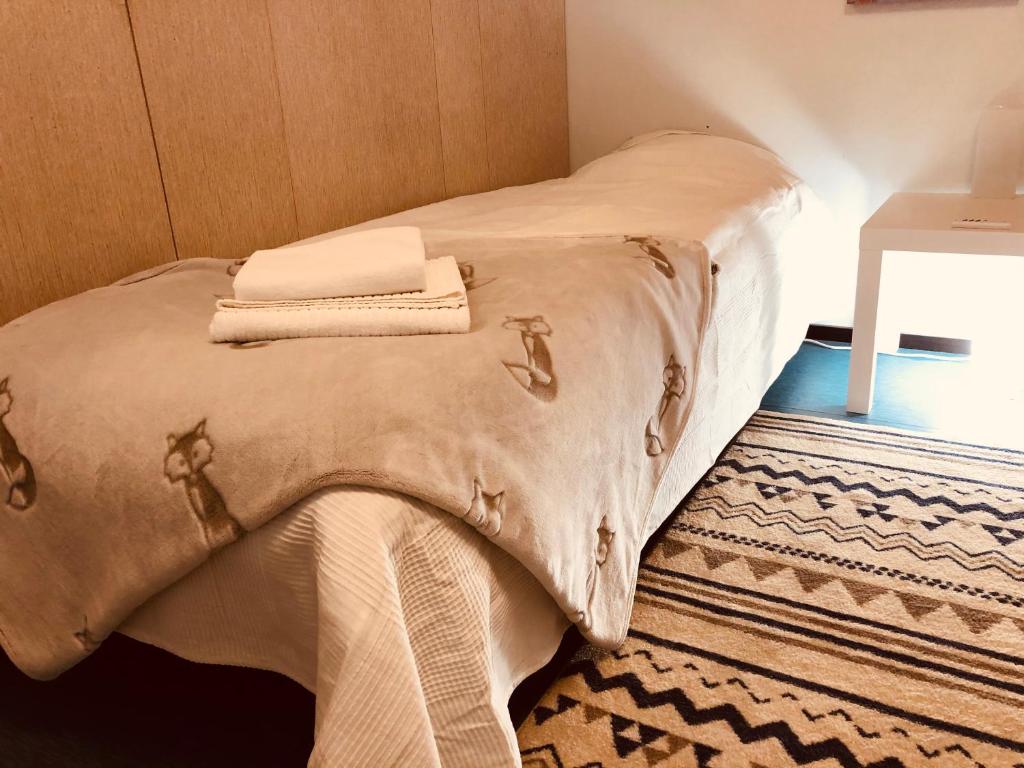 Una cama con dos toallas encima. en SUPER easy to airport/HKI , full aptment max 4ppl, en Helsinki