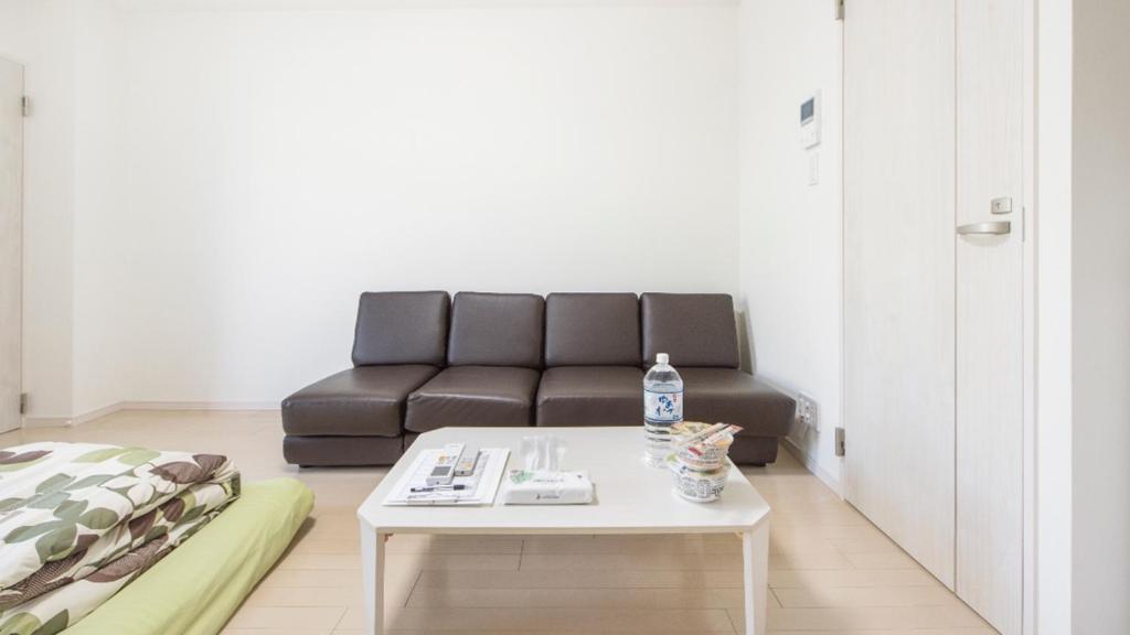 a living room with a couch and a coffee table at Marvelous Higashioi - Vacation STAY 13015v in Tokyo