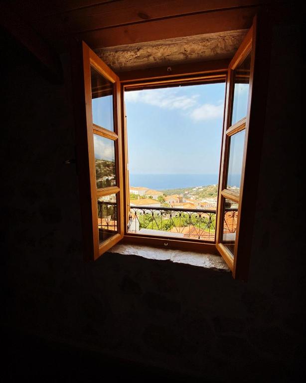 an open window with a view of the ocean at Roots Dhermi in Dhërmi