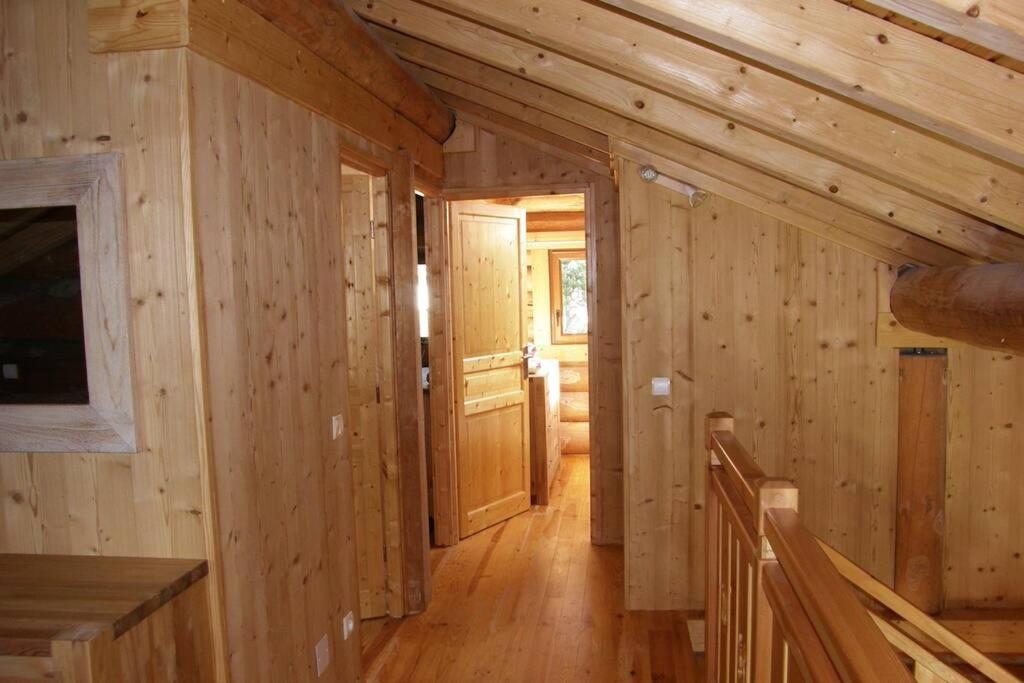 a hallway in a log cabin with wooden walls at Chalet les SORBIERS, en rondins, classé 4****étoiles in Bolquere Pyrenees 2000