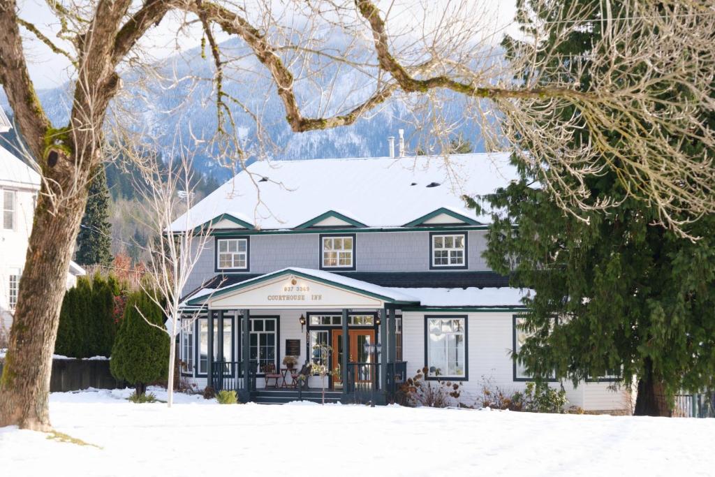 a house with a snow covered roof at Courthouse Inn Revelstoke in Revelstoke