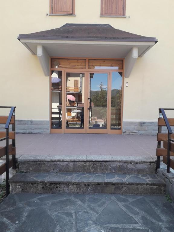 a entrance to a building with glass doors at Abetone - Parco dei Daini in Abetone