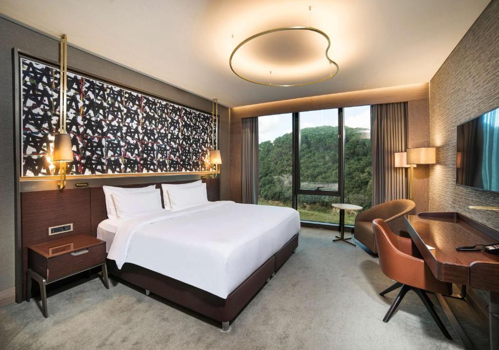 a bedroom with a bed and a desk and a computer at Radisson Collection Hotel, Vadistanbul in Istanbul