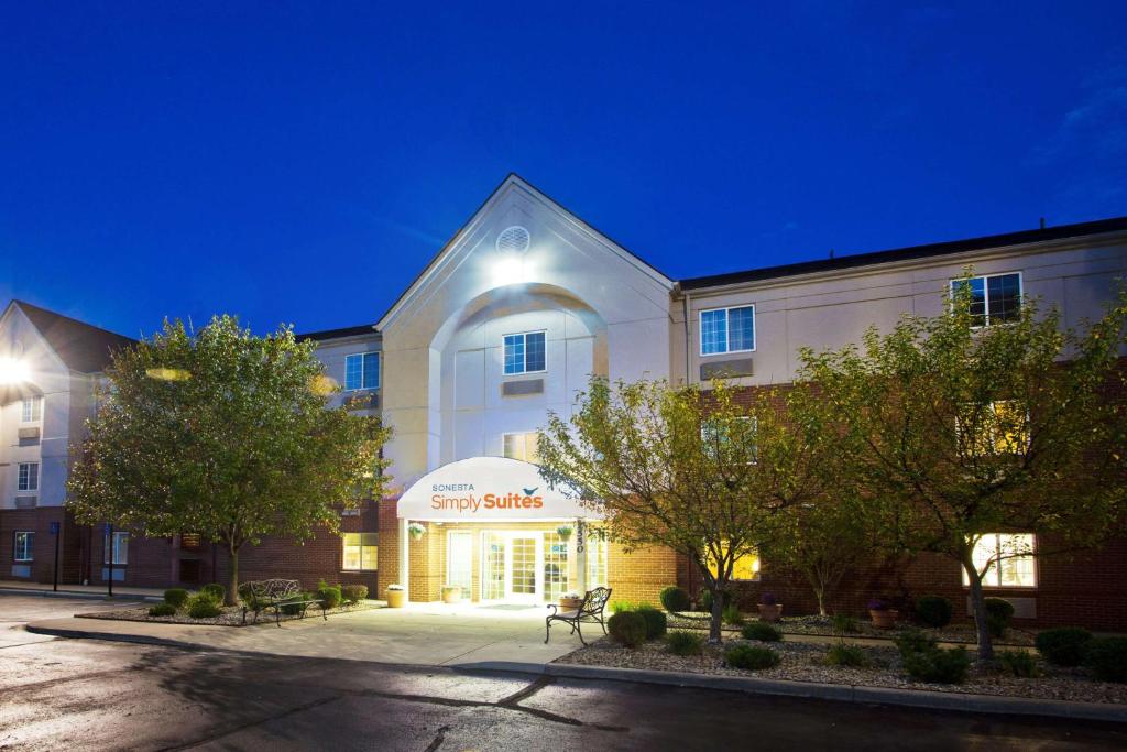 a large white building with a sign in front of it at Sonesta Simply Suites Detroit Troy in Troy