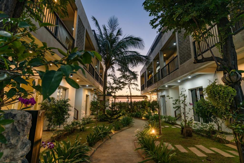 a courtyard of a building with plants and lights at Phka Kravan Boutique in Kampot
