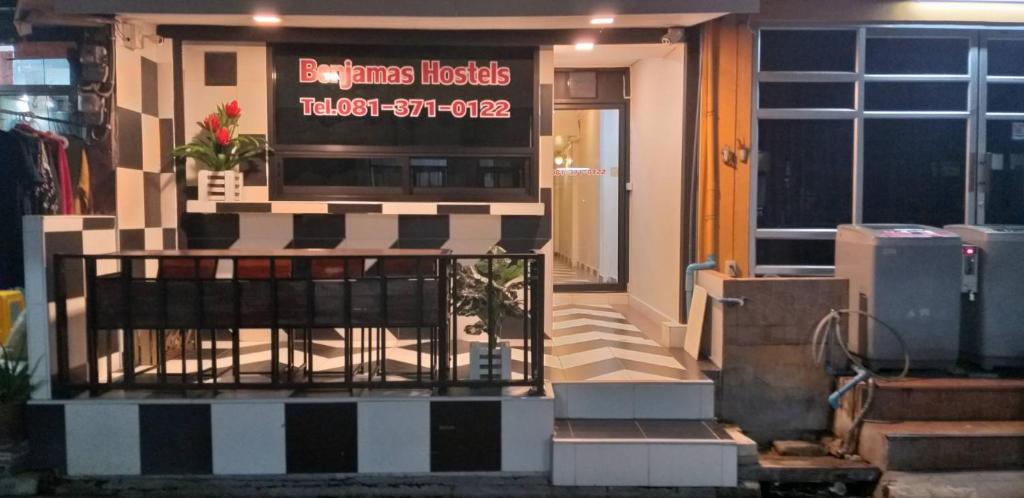 un ristorante con un cartello sulla parte anteriore di un edificio di Benjamas hostels a Bangkok