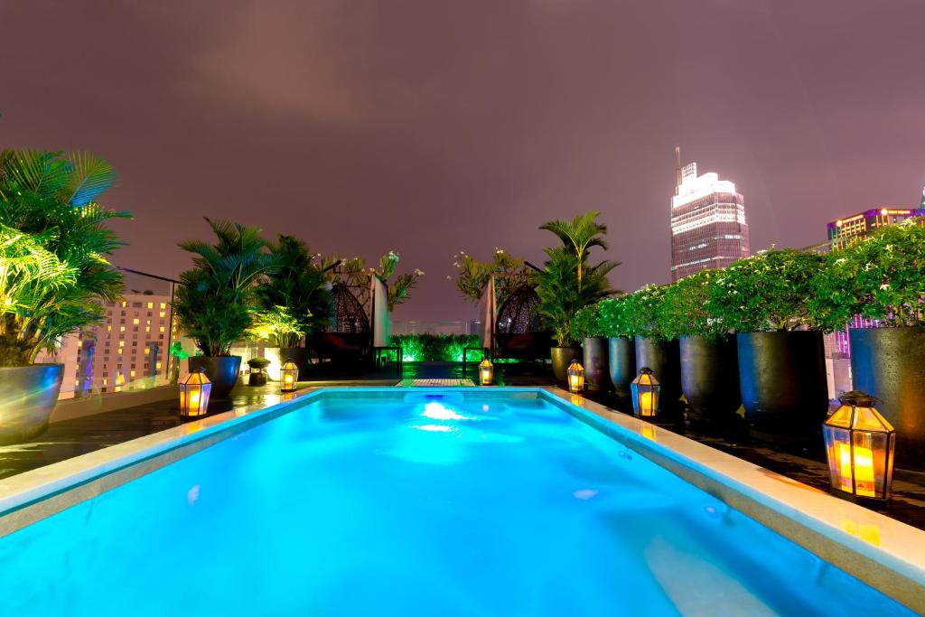 a swimming pool on top of a building at night at Roseland Sweet Hotel & Spa in Ho Chi Minh City
