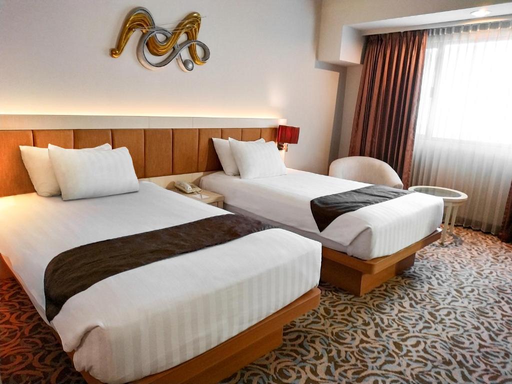 Postel nebo postele na pokoji v ubytování Verwood Hotel and Serviced Residence