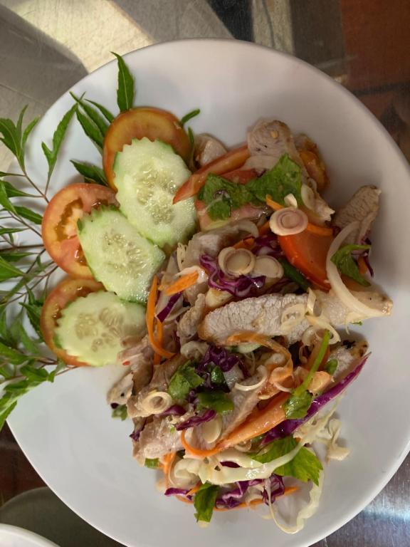 a white bowl of salad with meat and vegetables at Beck's Resort in Haad Pleayleam