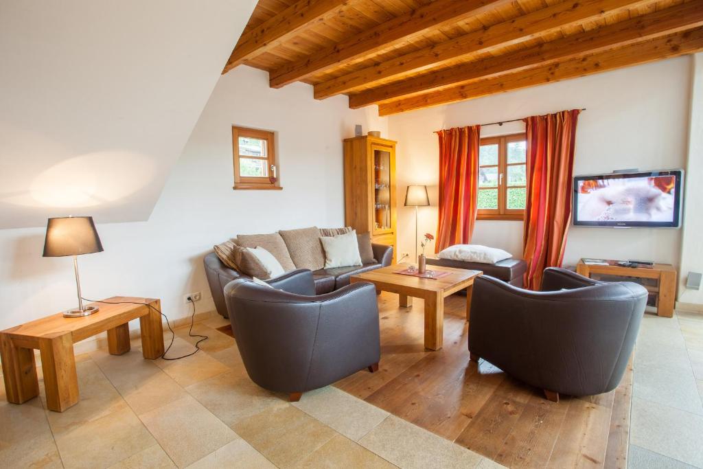 a living room with two couches and a table at Haus am Katzenbach in Garmisch-Partenkirchen