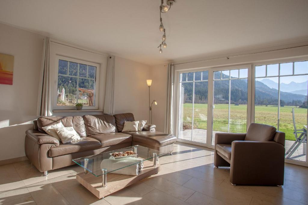 a living room with a couch and a glass table at Lebensfreude in Farchant