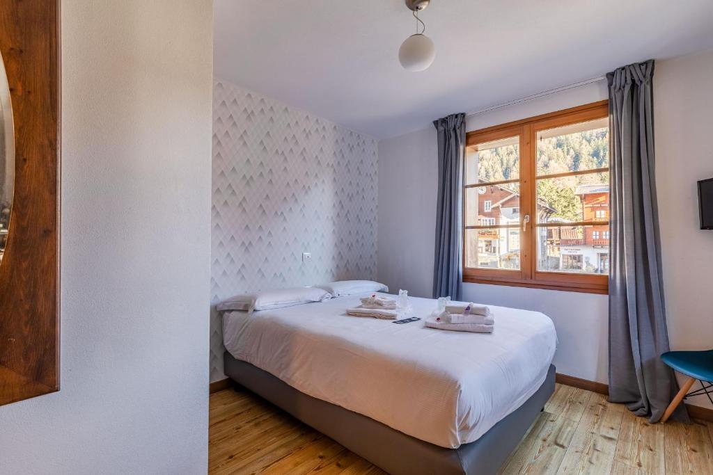 Postel nebo postele na pokoji v ubytování Hotel Dufour