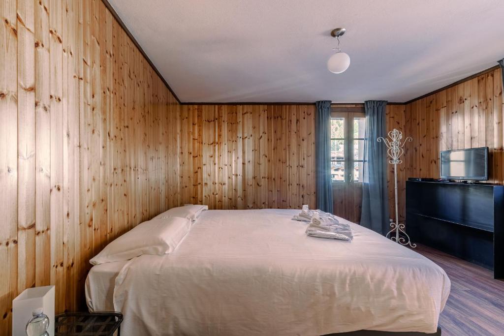 Postel nebo postele na pokoji v ubytování Hotel Dufour