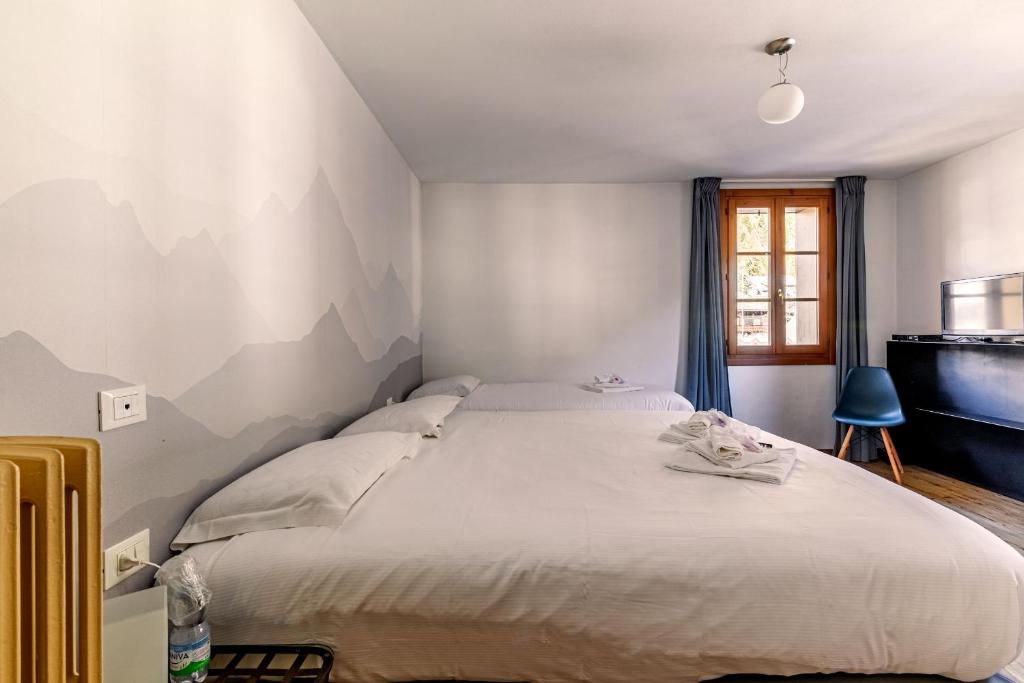 Postel nebo postele na pokoji v ubytování Hotel Dufour