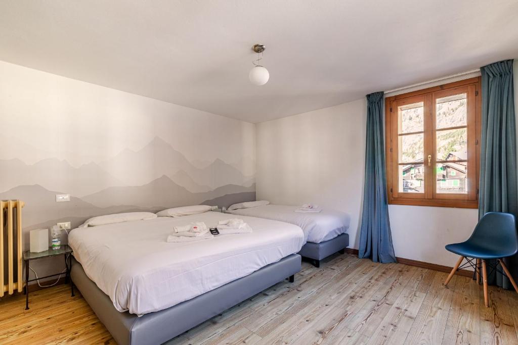 Postel nebo postele na pokoji v ubytování Hotel Dufour