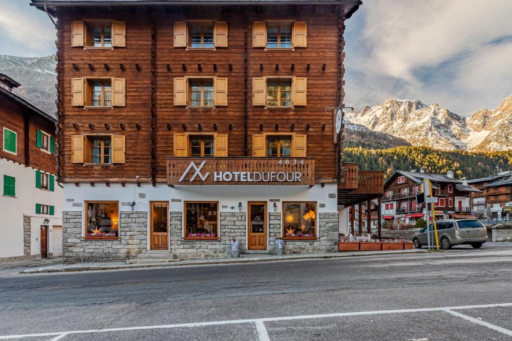 a building with a hotel on the side of a street at Hotel Dufour in Macugnaga