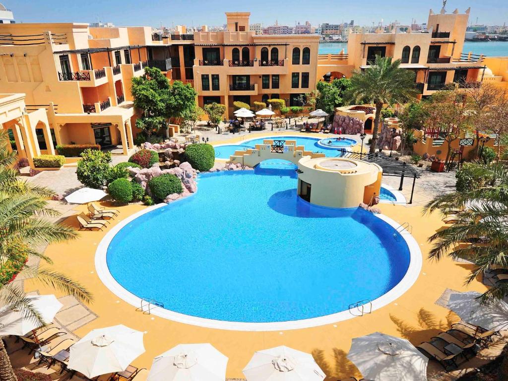 an overhead view of a swimming pool at a resort at Novotel Bahrain Al Dana Resort in Manama