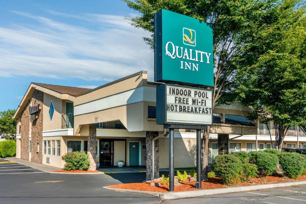 um sinal para uma estalagem de qualidade em frente a um edifício em Quality Inn Klamath Falls - Crater Lake Gateway em Klamath Falls