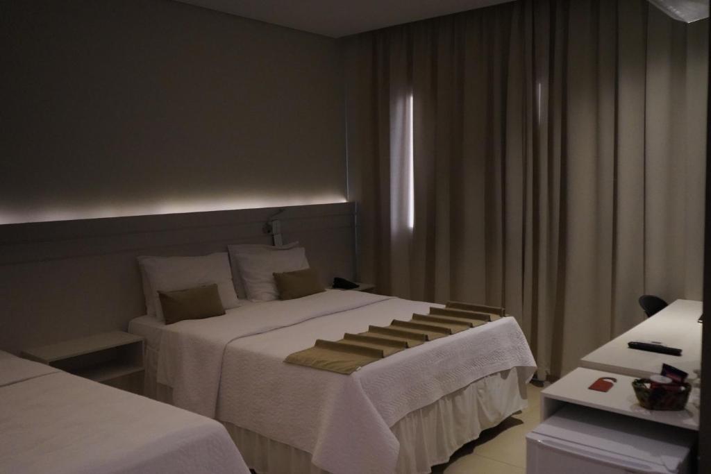 Postel nebo postele na pokoji v ubytování Pak Suítes Hotel