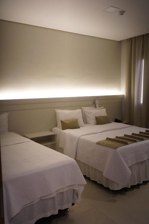 Postel nebo postele na pokoji v ubytování Pak Suítes Hotel