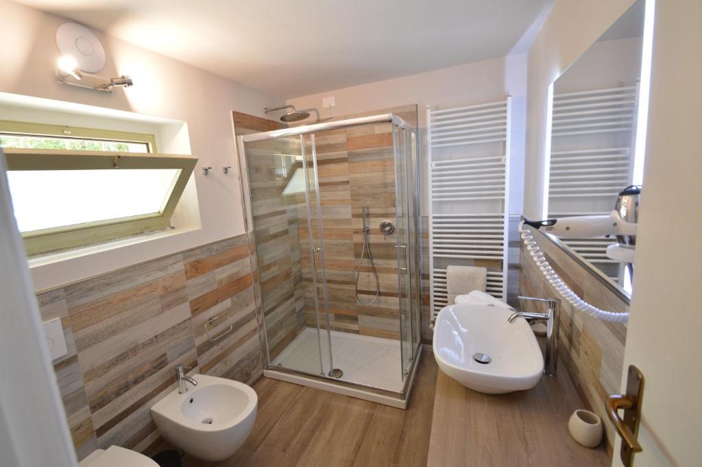 a bathroom with a shower and a toilet and a sink at Agriturismo La Filanda in Manerba del Garda
