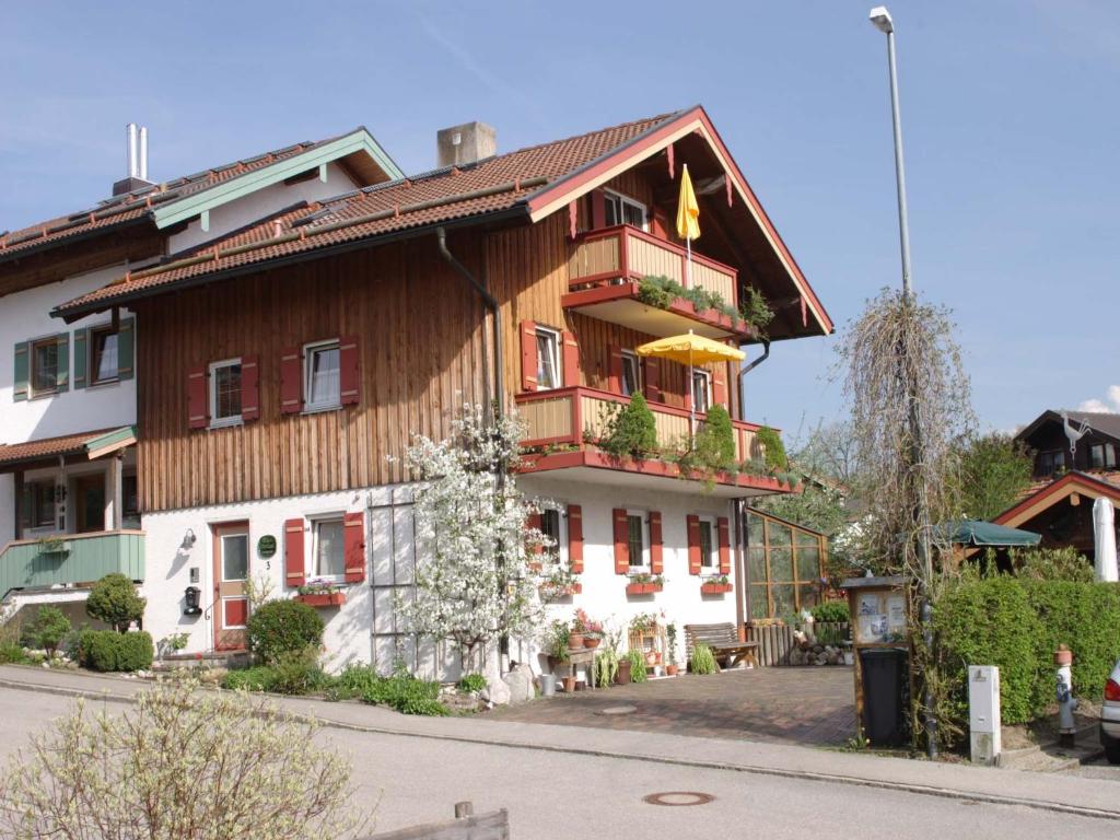 a large wooden house with a flag on it at Haus Oberland in Bad Endorf