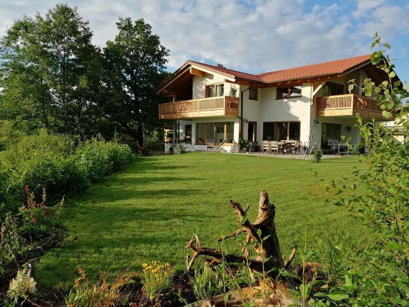 a large house with a large yard in front of it at Wolke 8 in Bernau am Chiemsee