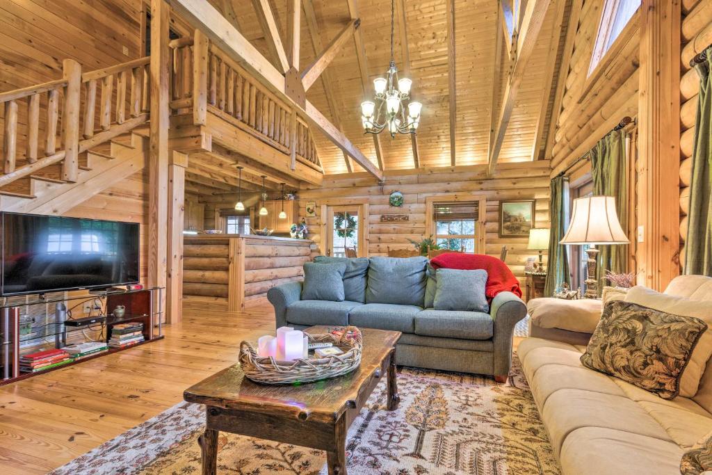 a living room with a couch and a table at Superb Linville Mountain Cabin with Wraparound Decks in Linville