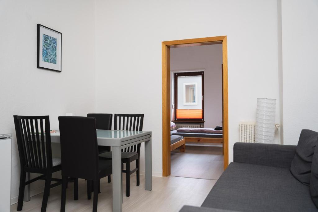 a dining room and living room with a table and chairs at 3 Zimmer Wohnung für max. 5 Personen in Alzey