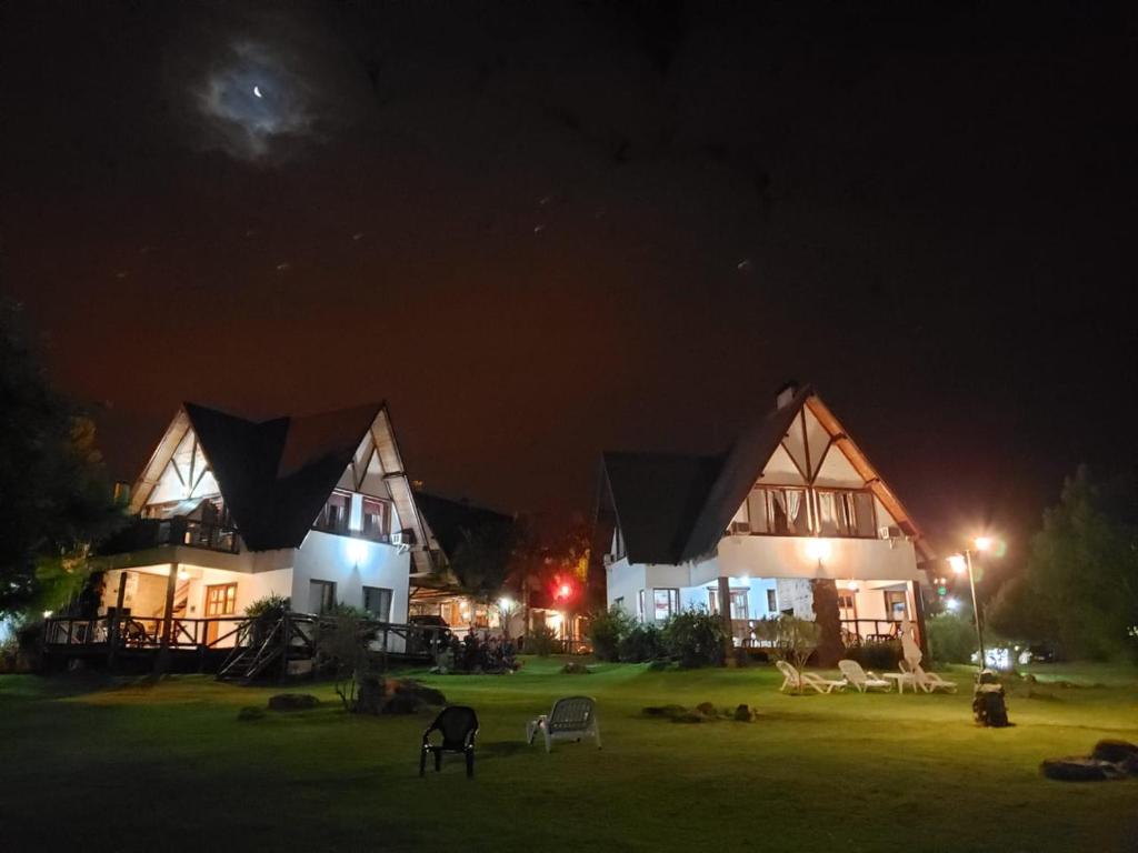 a couple of large buildings at night at Cabañas de Torre Colon in Colón