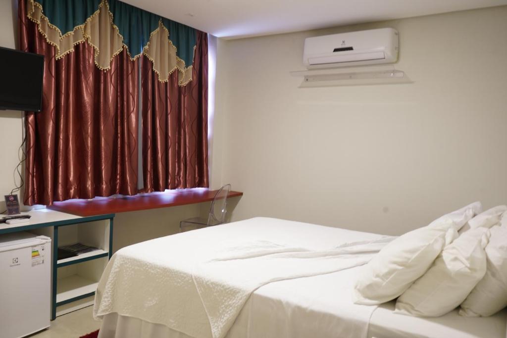 Postel nebo postele na pokoji v ubytování Pak Suítes Hotel