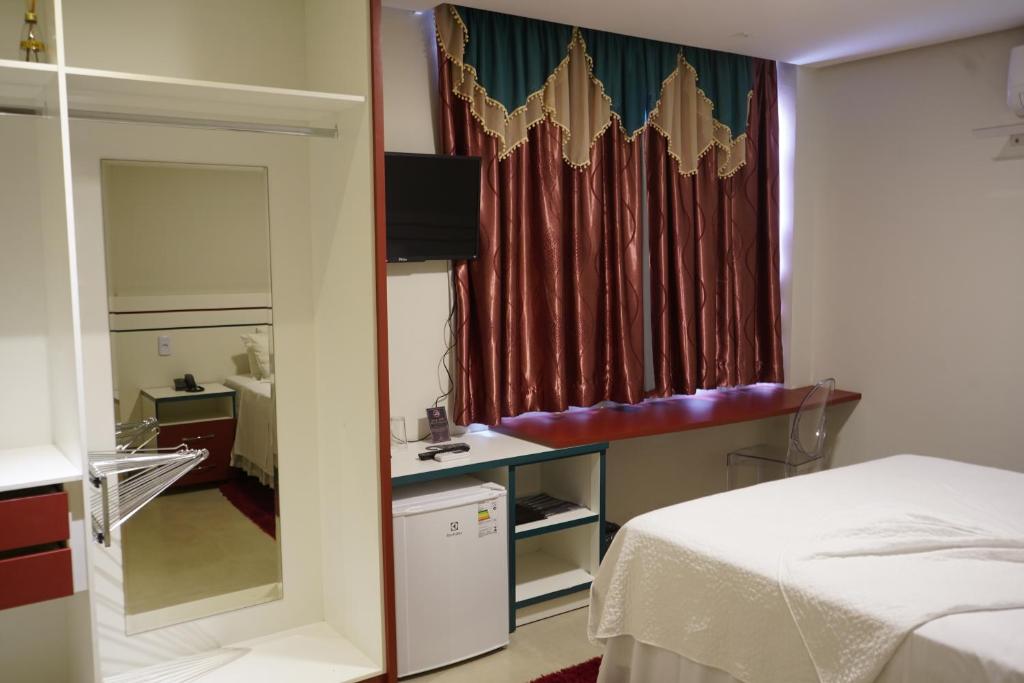 Postel nebo postele na pokoji v ubytování Pak Suítes Hotel