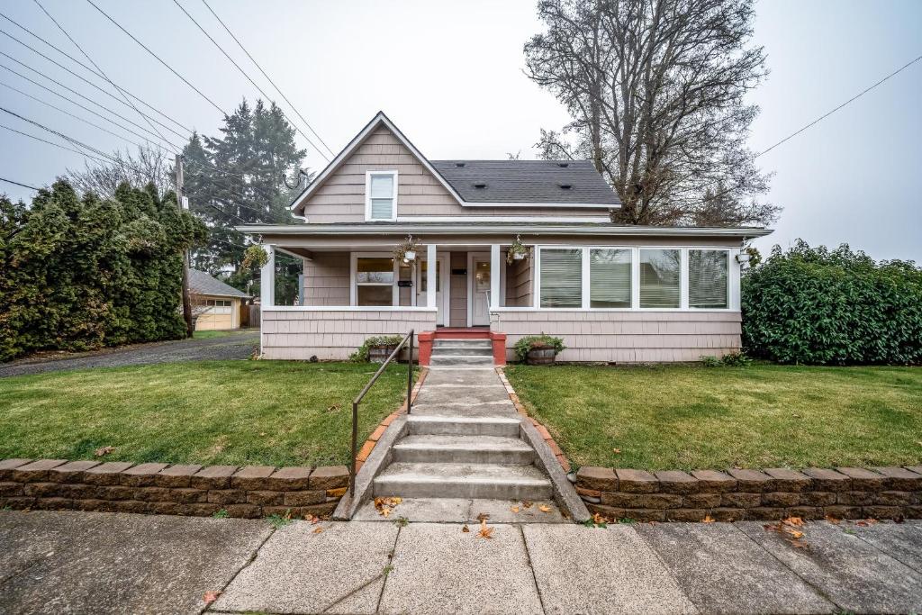 Casa blanca con una escalera que conduce a la puerta principal en The Craftsman House, en Springfield